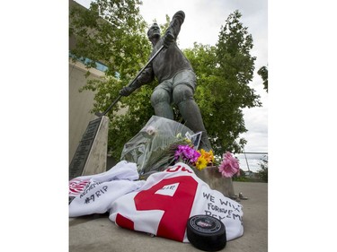 Flowers, jerseys, pucks and pictures lay next to the skates of the statue of Gordie Howe at SaskTel Centre in Saskatoon, June 10, 2016.