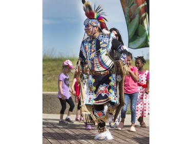 Visitors dance along with Indigenous dancers in the grand entry at the amphitheatre at Wanuskewin Heritage Park at the opening of the Aboriginal Day Celebration, June 21, 2016.