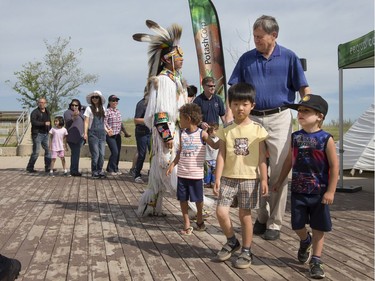 Visitors dance along with Indigenous dancers in the grand entry at the amphitheatre at Wanuskewin Heritage Park at the opening of the Aboriginal Day Celebration, June 21, 2016.