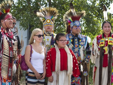 Olga Shmargan from Ukraine, now living in Saskatoon, has herself in a photo with the indigenous dancers after the grand entry in the amphitheatre at Wanuskewin Heritage Park at the opening of the Aboriginal Day Celebration, June 21, 2016.