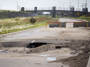 The north end of McOrmond Drive passed the walking bridge is closed due to this sink hole due to a damaged primary water main which has cause a drinking water advisory in the area of the city, June 27, 2016.