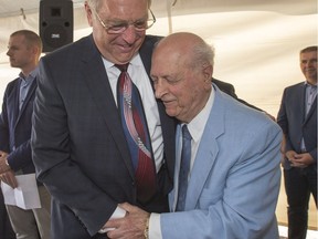 Karim Nasser of Victory Majors and Mayor Don Atchison hug to celebrate sod turning for Parcel Y.