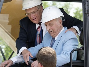 Karim Nasser, Victory Major Investment Group and Saskatoon Mayor Don Atchison  inside the cab of a back-hoe turning the sod for Saskatoon's Parcel Y project which is finally a go, June 29, 2016.