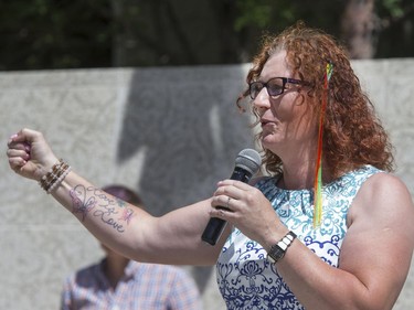 Pride Week speaker Laura Budd displays her "Love is Love " tattoo during her speech to the large crowd that attended the Pride Week flag raising at City Hall in Saskatoon, June 6, 2016.