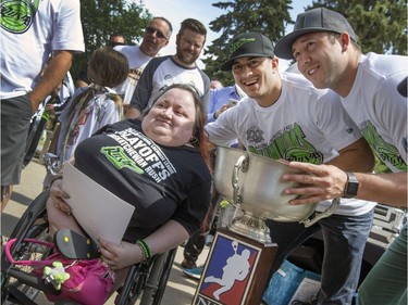 Buffy Ash gets her picture taken with Rush players Mark Matthews and Nick Bilic at a champions rally for NLL Champions the Saskatchewan Rush in Bessborough Gardens, June 7, 2016.