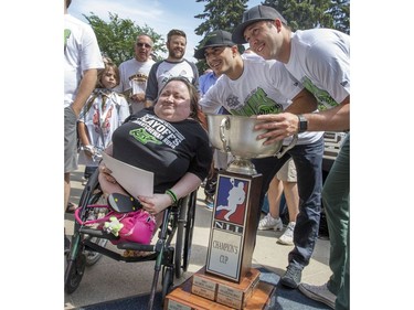 Buffy Ash gets her picture taken with Rush player Mark Matthews and Nick Bilic at a champions rally for NLL Champions the Saskatchewan Rush in Bessborough Gardens, June 7, 2016.