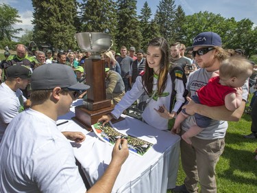 Saskatchewan Rush players Mark Matthews, Nick Bilic and Robert Church with the NLL cup for pictures and autographs at a champions rally for NLL Champions the Saskatchewan Rush in Bessborough Gardens, June 7, 2016.