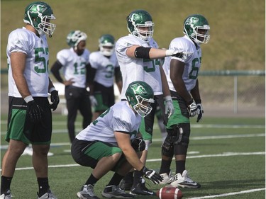 The offensive line points out their blocks at Saskatchewan Roughriders practice in Saskatoon, June 8, 2016.