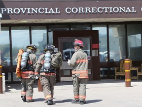 Firefighters head into the Saskatoon Correctional Centre after a riot on May 28, 2015.