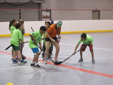 Kids practice hockey drills during the Saskatoon Teammates Procamp in Saskatoon, June 11, 2016.