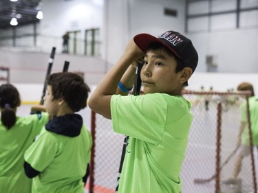 Kids practice hockey drills during the Saskatoon Teammates Procamp in Saskatoon, June 11, 2016.