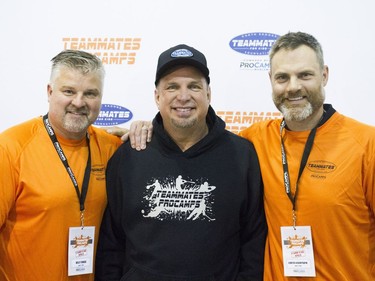 L-R: Kelly Chase, Garth Brooks and Curtis Leschyshyn pose during a media scrum at the Saskatoon Teammates Procamp in Saskatoon, June 11, 2016.