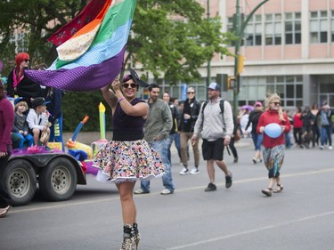 Attendees march through downtown Saskatoon during the Saskatoon Pride Parade, June 11, 2016.
