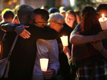 Yolanda Verhoef and Aiden Aichele hug each other after the candlelight vigil for the 50 lives lost during the Orlando shooting at Saskatoon's City Hall on Sunday night, June 12, 2016.