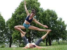 SASKATOON, SK - June 14, 2016 - Alyssa Hegel strikes a pose on Diane Crawford at the Acro Yoga Jam at Rotary Park Tuesday evening in Saskatoon. (Michelle Berg / Saskatoon StarPhoenix)