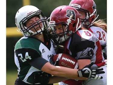 Valkyries' Ehjae Chan tackles Riot's Rachelle Smith during first half action at the Saskatoon Valkyries vs. Regina Riot conference final at SMF Field in Saskatoon, June 19, 2016.