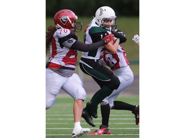 Valkyries' Julene Friesen tries to jump past a tackle from Riot's Jessie Noname and Nikki Broom during first half action at the Saskatoon Valkyries vs. Regina Riot conference final at SMF Field in Saskatoon, June 19, 2016.