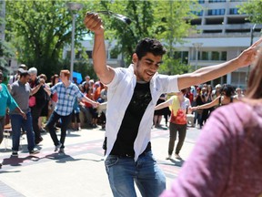 Abdullah Seif Aldeen, an 18-year-old Syrian refugee from Damascus, leads the public in a traditional Syrian dance during a World Refugee Day celebration in City Hall Square on Monday.