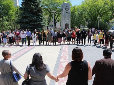 Residents of Saskatoon share a round circle dance during World Refugee Day put on by the Saskatoon Refugee Coalition at Civic Square at City Hall in Saskatoon on June 20, 2016.