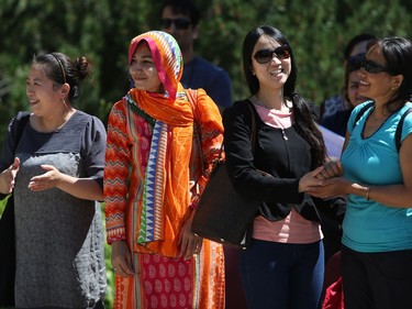 People gather for World Refugee Day put on by the Saskatoon Refugee Coalition at Civic Square at City Hall in Saskatoon on June 20, 2016.