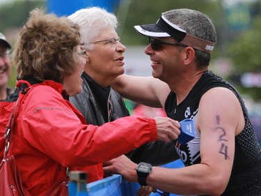 Doug Rotzien stops to greet family during the transition from cycling to running in the Subaru 5i50 Saskatoon Triathlon on June 26, 2016.