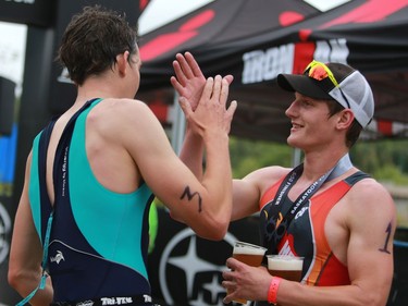 Doug Wickware high fives James Cook after finishing second in the Subaru 5i50 Saskatoon Triathlon on June 26, 2016.