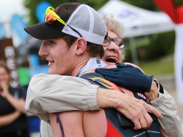 James Cook hugs a family member after finishing first in the Subaru 5i50 Saskatoon Triathlon on June 26, 2016.