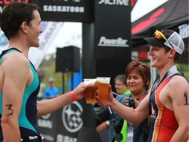 Second place Doug Wickware cheers' first place James Cook after finishing the Subaru 5i50 Saskatoon Triathlon on June 26, 2016.