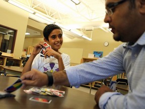 Mansour Hamandoush plays Uno with his Educational Assistant Raed Aljamous at WP Bate Community School in Saskatoon on June 28, 2016.