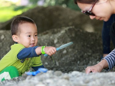 Kevin Xie and May Huang dig for fossils during the PotashCorp Children's Festival at Kiwanis Park in Saskatoon, June 5, 2016.