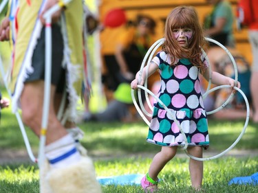 Three-year-old Emma Koenig learns how to make a butterfly during hoop dance lessons at the PotashCorp Children's Festival at Kiwanis Park in Saskatoon, June 5, 2016.