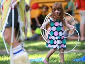 Three-year-old Emma Koenig learns how to make a butterfly during hoop dance lessons at the PotashCorp Children's Festival at Kiwanis Park June 5 in Saskatoon.