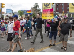 People walk down 20th Street East during the Pride Parade in Saskatoon on June 13.