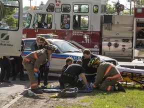 A person injured in an accident at 29th and Idylwyld Drive is taken to ambulance, Wednesday, June 01, 2016.