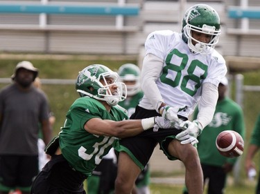 Defensive back Joel Brtka, left, hits Marquez Clark, wide receiver, in action at Rider camp action at Griffiths Stadium in Saskatoon, Thursday, June 02, 2016.