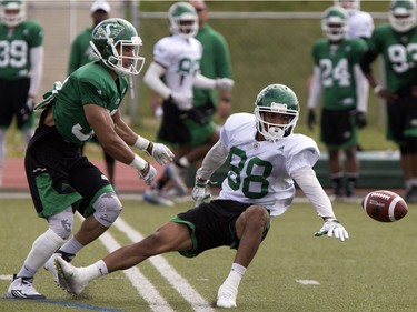 Defensive back Joel Brtka, left, hits Marquez Clark, wide receiver, in action at Rider camp action at Griffiths Stadium in Saskatoon, Thursday, June 02, 2016.