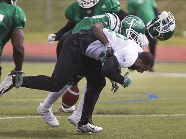 John Chiles, wide receiver, gets rocked by Ed Gainey, defensive back in Rider camp action at Griffiths Stadium in Saskatoon, Thursday, June 02, 2016.