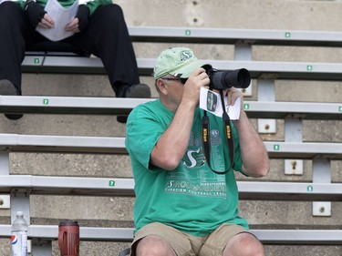 A fan works to get a photo of the action of Rider training camp at Griffiths Stadium in Saskatoon, Friday, June 03, 2016.