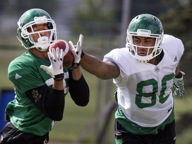 Spencer Moore, fullback, right, tries to slap the ball from the grasp of Marte Sears, linebacker, during Rider training camp at Griffiths Stadium in Saskatoon, Friday, June 03, 2016.