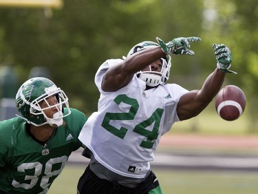 Terrance Cobb, right, just misses the catch against the defence of Marte Sears, linebacker in Rider training camp at Griffiths Stadium in Saskatoon, Friday, June 03, 2016.