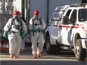 Saskatoon Fire department members in protective suits on scene of a hazardous materials investigation in 1300 block of 2nd Avenue North, Wednesday, June 08, 2016.