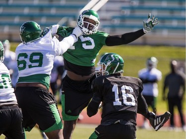 New signing #75 Jonathan Williams rushes quarterback Brett Smith but is blocked by offensive lineman Kennedy Estelle during Roughrider training camp at Griffiths Stadium, June 15, 2016.