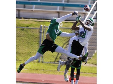 Defensive back Xavier Walker knocks the ball away from wide receiver Naaman Roosevelt during Roughrider training camp at Griffiths Stadium, June 15, 2016.