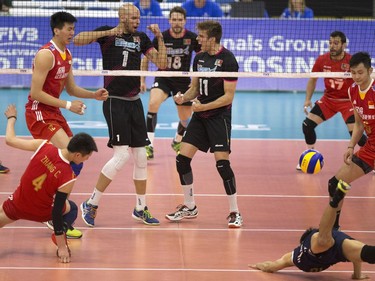 Portugal players #1 Marcel Keller Gil and Joao Oliveira celebrate a point against China during FIVB World Volleyball League action at Sasktel Centre in Saskatoon, June 24, 2016.