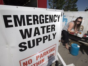 Erica Schindel fills a couple of water jugs at No. 9 fire hall on Attridge Drive, Tuesday, June 28, 2016. A construction crew hit a water main in the area Monday causing a boil water advisory for much of the northeast sector of Saskatoon.