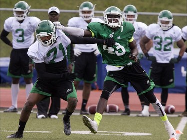 Wide receiver Randy Roseway (L) and defensive back Kentrell Everett in action during Roughrider camp at Griffiths Stadium, May 31, 2016.