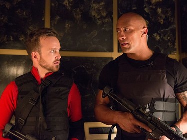 Aaron Paul (L) and Dwayne Johnson star in "Central Intelligence."