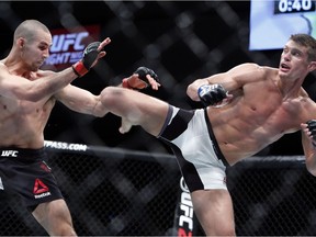 Stephen Thompson, right, kicks to the body of Rory MacDonald during UFC welterweight bout in Ottawa on Saturday June 18, 2016. Thompson won a unanimous decision over MacDonald in a battle of top welterweight contenders at UFC Fight Night 89 Saturday night.