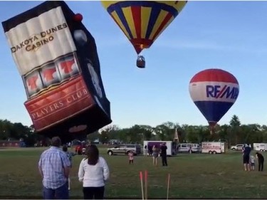 Three hot air balloons took to the sky on Wednesday night at Kinsmen Park as spectators watched the giant inflatable bodies fill with air and take off, June 22, 2016.