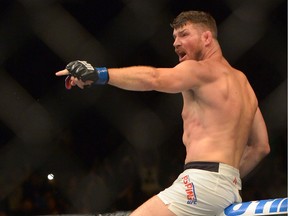 INGLEWOOD, CA - JUNE 04: Michael Bisping points to opponent Luke Rockhold after defeating him in their Middleweight Title Bout at UFC 199 at The Forum on June 4, 2016 in Inglewood, California.